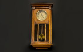 A 1930's Wall Mounted Clock In rectangular glazed case, Of typical form with brass dial.