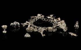 A Vintage Silver Curb Bracelet - Loaded with 25 Silver Charms.