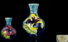 W. Moorcroft Signed Small Tubelined Vase ' Hibiscus ' Variations on Blue Ground.