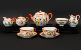 Japanese Part Tea Service Comprising teapot, two cups and accompanying saucers,