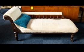 Chaise Longue Of large proportions with carved headrest and spindle back,