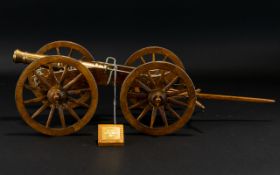 A Model Replica French 12 Pounder Field Canon Oak case, metal trim and brass canon.