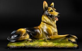 A Chalkware Figure In The Form Of A Recumbent German Shepherd Dog Some chips/damage to paint