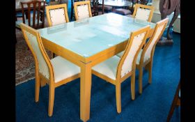 A Contemporary Kitchen Table And Chairs Finished in pale coloured composite with rectangular glass