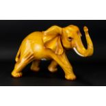 A Carved Wooden Elephant standing position with raised trunk, attractive style, height 10".