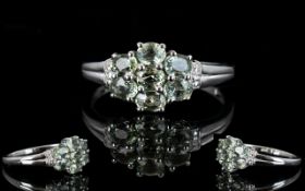 Green Sapphire Seven Stone Cluster Ring, seven oval cuts of the olive green 'fancy' sapphire,