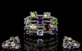 Multi Gem Four Row Scatter Ring, two round cuts of each, amethyst, red garnet, sky blue topaz,