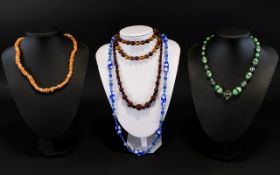 A Small Collection Of Vintage Beaded Glass Necklaces Five in total to include graduated claret and