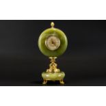 A Green Onyx Mantle Clock Raised on circular onyx base with gilt dolphin mask feet,