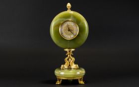 A Green Onyx Mantle Clock Raised on circular onyx base with gilt dolphin mask feet,