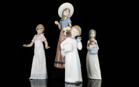A Collection of Four Nao Figures of various styles and sizes,