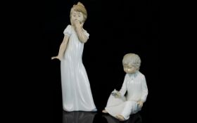 Nao by Lladro Pair of Porcelain Figure - Depicts Young Boy and Girl In Nightdress's,