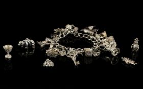 A Vintage Silver Curb Bracelet - Loaded with 25 Silver Charms.