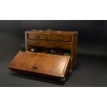 An Engineers Desktop Chest Of Tools Comprising fall front, two short,