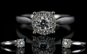 A 9ct White Gold Diamond Cluster Ring Central round brilliant cut diamond surrounded by a further