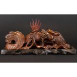 An Oriental Carved Figure In The Form Of A Dragon,