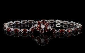 Red Garnet Line and Flower Bracelet, a floral shape comprising six pear cut red garnets,