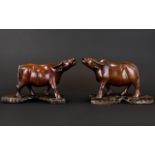 A Pair Of Oriental Carved Animal Figures In the form of water buffalo,