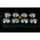 A Set of French Boules in a green canvas carry bag.