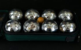 A Set of French Boules in a green canvas carry bag.