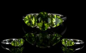 Peridot Three Stone Ring, a 2ct oval cut