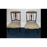 A Pair Of Mahogany Edwardian Salon Chairs. Inlaid slats, turned supports with brass castors.