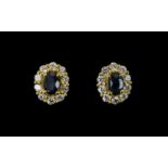 Sapphire and White Zircon Cluster Stud Earrings, each .5ct oval cut blue sapphire framed with .