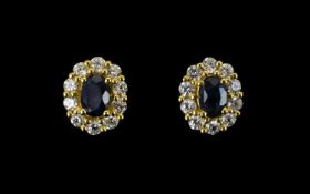 Sapphire and White Zircon Cluster Stud Earrings, each .5ct oval cut blue sapphire framed with .