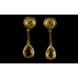 Citrine Pair of Drop Earrings, each earring comprising a bezel set, pear cut citrine, suspended,