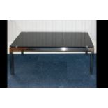 A Modern Glass Coffee Table Rectangular form in chromed metal and black glass, height 17 inches,