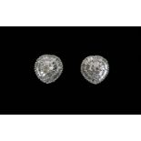 Pair of Diamond Cluster Earrings, a raised centre of round cut diamonds, closely framed with two