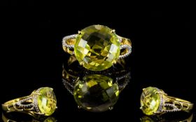 Ouro Verde Green Gold Quartz Solitaire Ring, a 7.5ct round cut green gold quartz with chequerboard