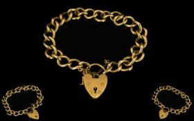 9ct Gold Heavy Curb Bracelet with Attached 9ct Gold Shield Shaped Padlock and Safety Chain.