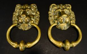 A Pair of Brass Door knockers traditional lion mask brass door knockers each with aperture for