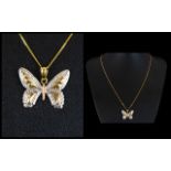 A beautiful 9 ct gold butterfly pendant & Chain, In a tri-colour design,