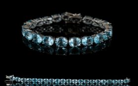 Sky Blue Topaz Tennis Bracelet, a row of 21 oval cut sky blue topaz, each stone being over 2cts,