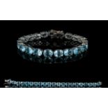 Sky Blue Topaz Tennis Bracelet, a row of 21 oval cut sky blue topaz, each stone being over 2cts,