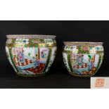 A Pair Of Oriental Fish Bowls / Jardinieres Each with gilt rim and traditional floral design.