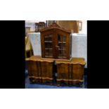 A Pair Of Shaped Three Drawer Mini Bedside Cabinets Dark wood,