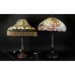 Two Tiffany Style Stained Glass Table Lamps Each raised on reproduction art nouveau cast metal