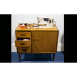 A Vintage Singer Sewing Machine In Original Mid-Century Cabinet with four drawers with integral