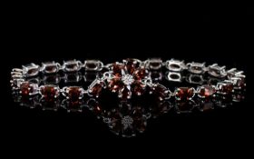 Red Garnet Line and Flower Bracelet, a floral shape comprising six pear cut red garnets, centred