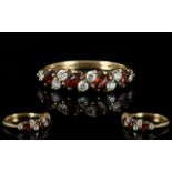 Ladies 9ct Gold Attractive Garnet and CZ Dress Ring fully hallmarked for 9.375, ring size M.