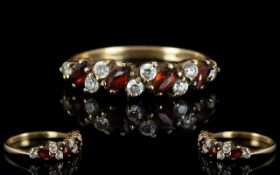 Ladies 9ct Gold Attractive Garnet and CZ Dress Ring fully hallmarked for 9.375, ring size M.