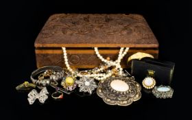 A Carved Wooden Box Containing A quantity Of Costume Jewellery Items A varied collection to include