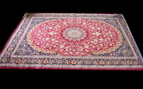 A Very Large Woven Silk Carpet Keshan rug with red ground and traditional Middle Eastern floral and