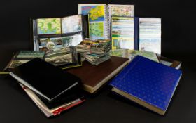A Large Collection Of Postcards Comprising twelve slim albums along with various loose cards.