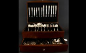 A Modern Canteen Of Cutlery Hinged top mahogany veneer box with single drawer and twin handles.