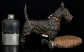 A Cast Metal Novelty Lighter In The Form Of A Highland Terrier Dog Along with two vintage hip