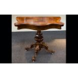 Walnut Veneer Card Table Raised on carved base with quatrefoil legs on castors.